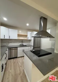 a kitchen with a stove a sink and a refrigerator