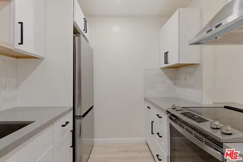 a kitchen with a stove and a refrigerator