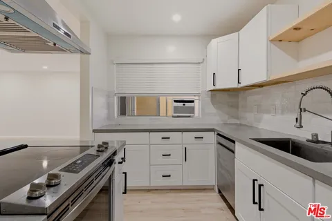 a kitchen that has a sink and a stove
