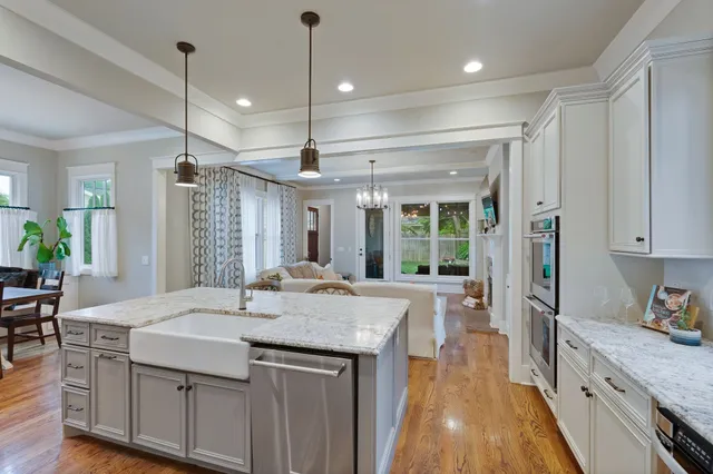 a kitchen with sink stove and refrigerator