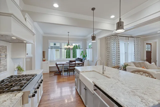 a kitchen with sink stove and view living room