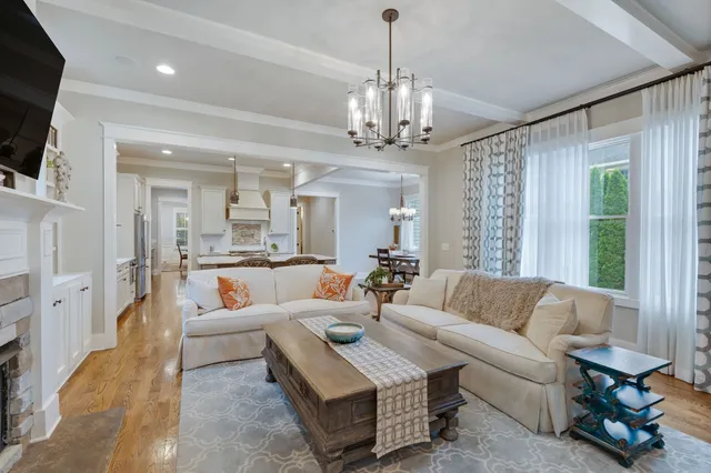 a living room with furniture and a chandelier