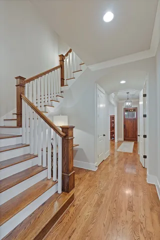 a view of entryway and hall with wooden floor