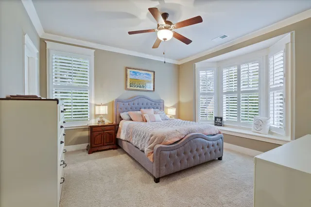 a spacious bedroom with a bed and a large window