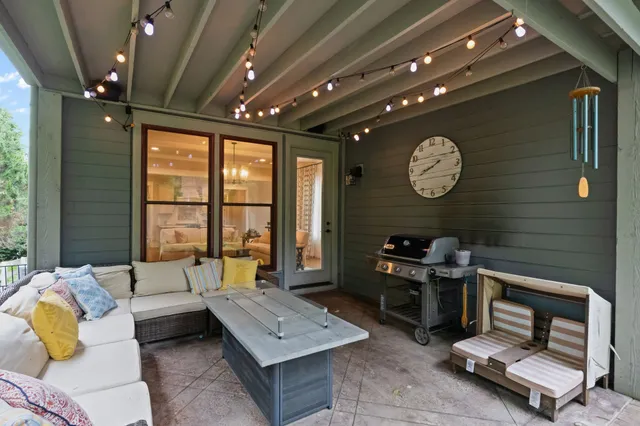 a living room with furniture a window and a clock