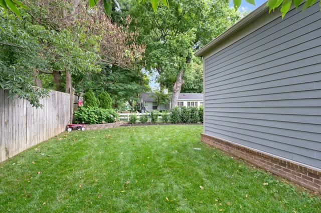 a view of backyard with a garden and trees