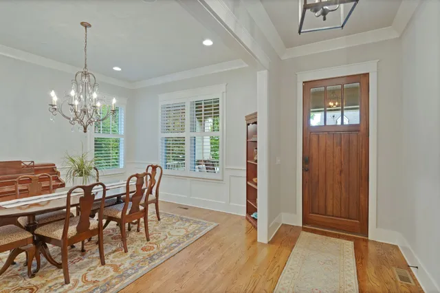 a view of a dining room with furniture and chandelier