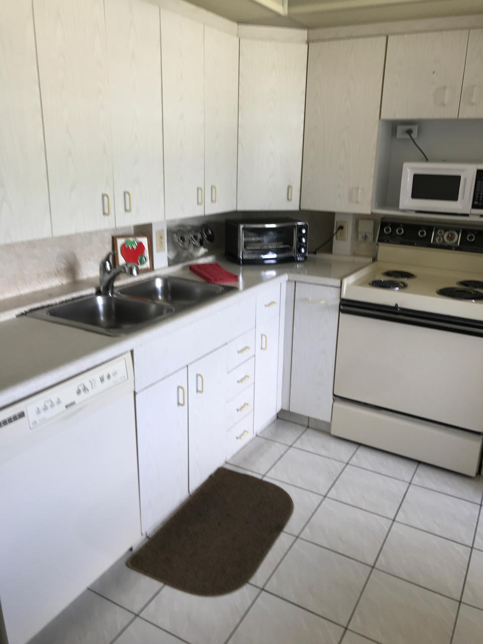 2073 Exeter, Unit E Boca Raton, FL 33434 - Photo 11 of 27 a kitchen with stainless steel appliances granite countertop a sink stove and cabinets
