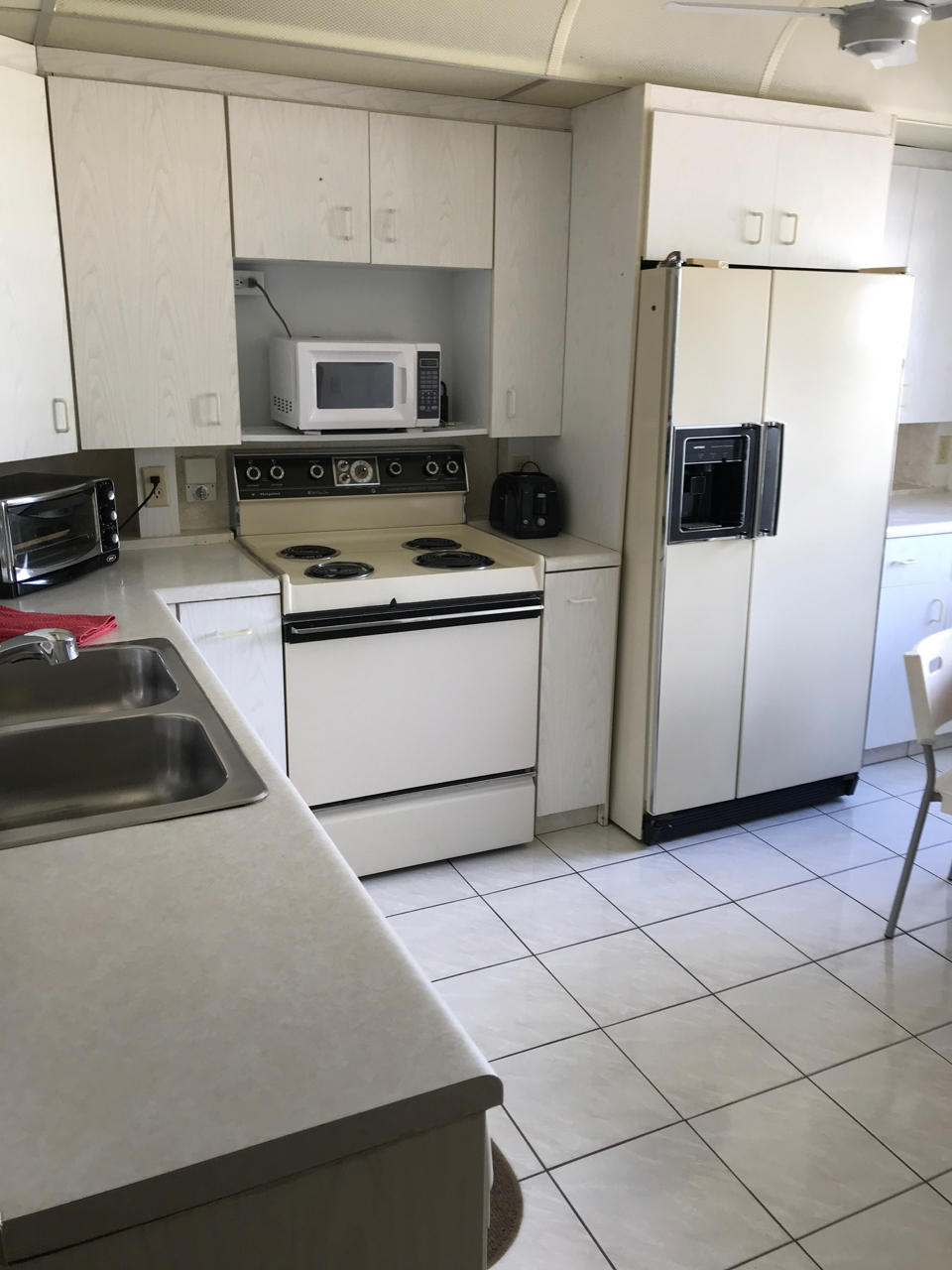 2073 Exeter, Unit E Boca Raton, FL 33434 - Photo 12 of 27 a kitchen with cabinets and steel stainless steel appliances