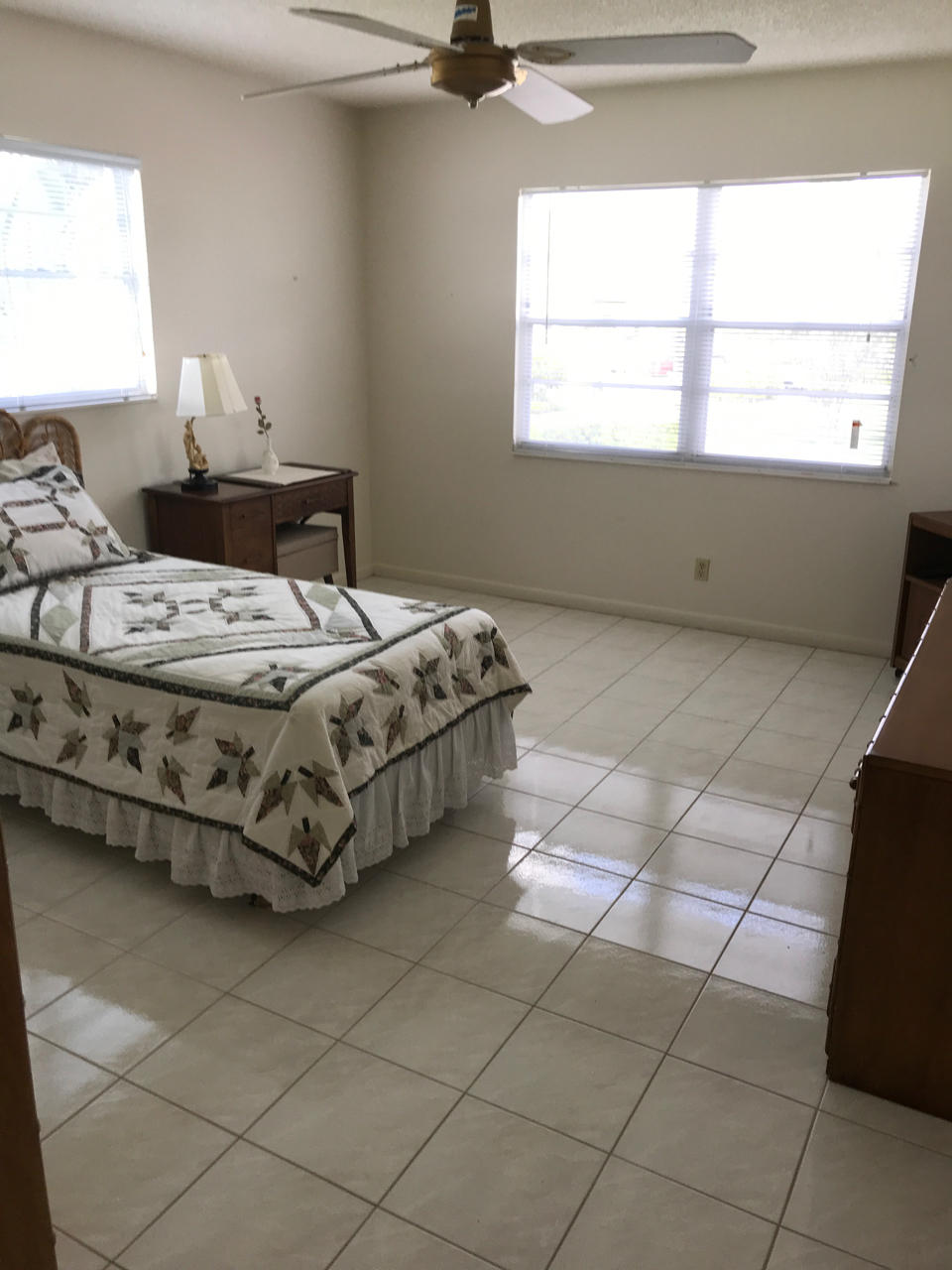 2073 Exeter, Unit E Boca Raton, FL 33434 - Photo 14 of 27 a bedroom with a bed and a window