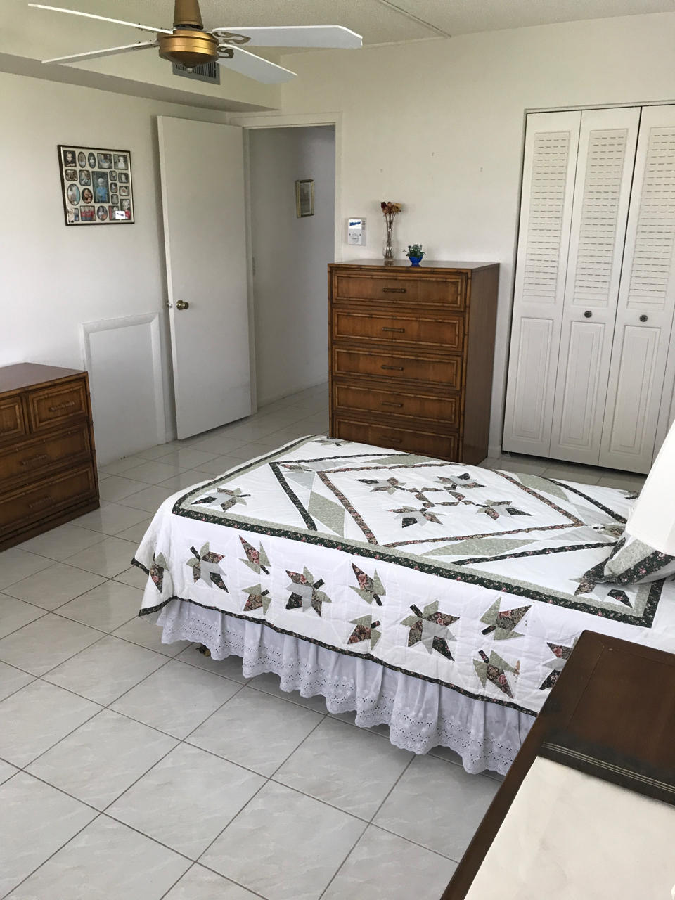 2073 Exeter, Unit E Boca Raton, FL 33434 - Photo 15 of 27 a bedroom with a bed and cabinets