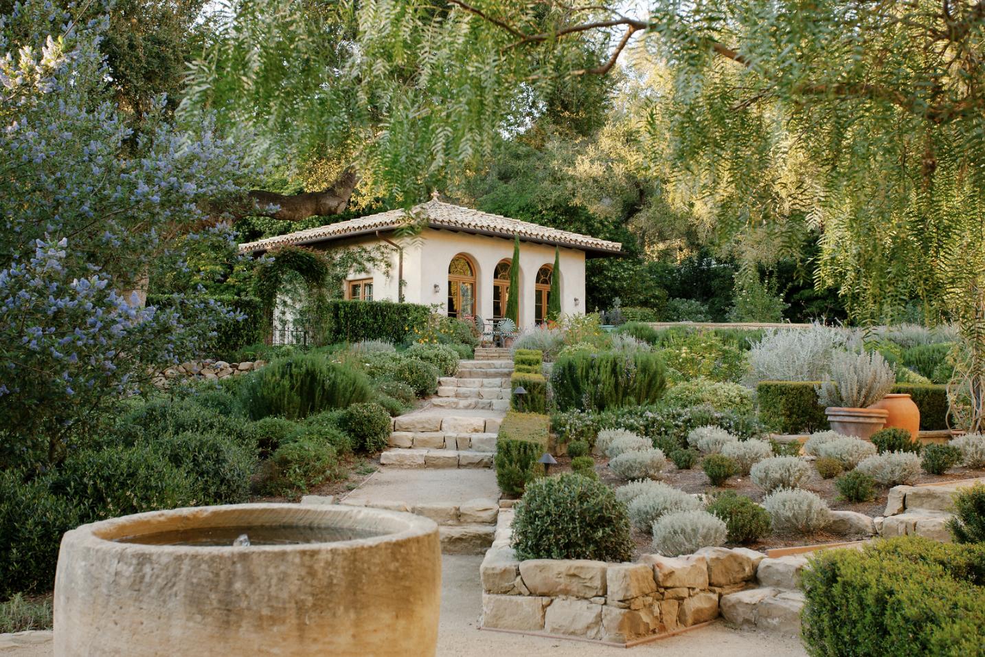 854 Rockbridge Road Santa Barbara, CA 93108 - Photo 11 of 34 a view of a house with a yard plants and large tree