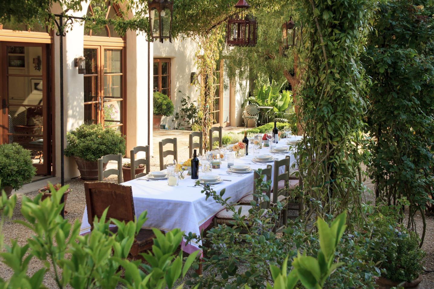 854 Rockbridge Road Santa Barbara, CA 93108 - Photo 12 of 34 a view of a patio with table and chairs potted plants and large tree