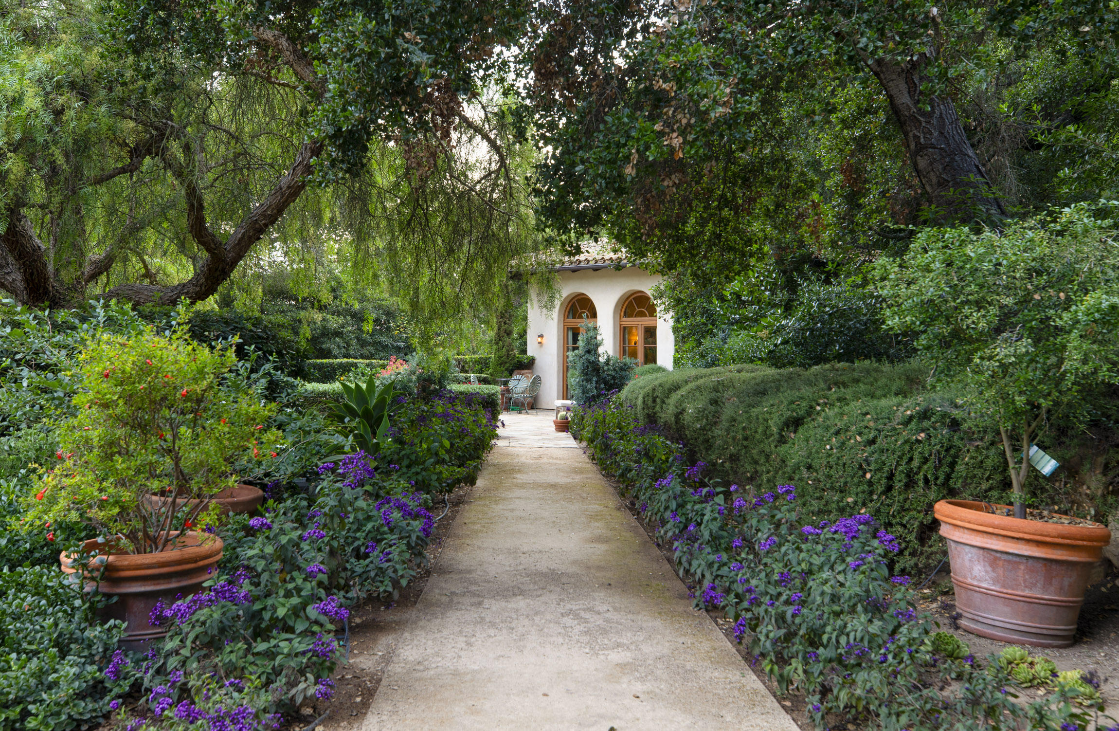 854 Rockbridge Road Santa Barbara, CA 93108 - Photo 13 of 34 a house with lots of flowers in front of it