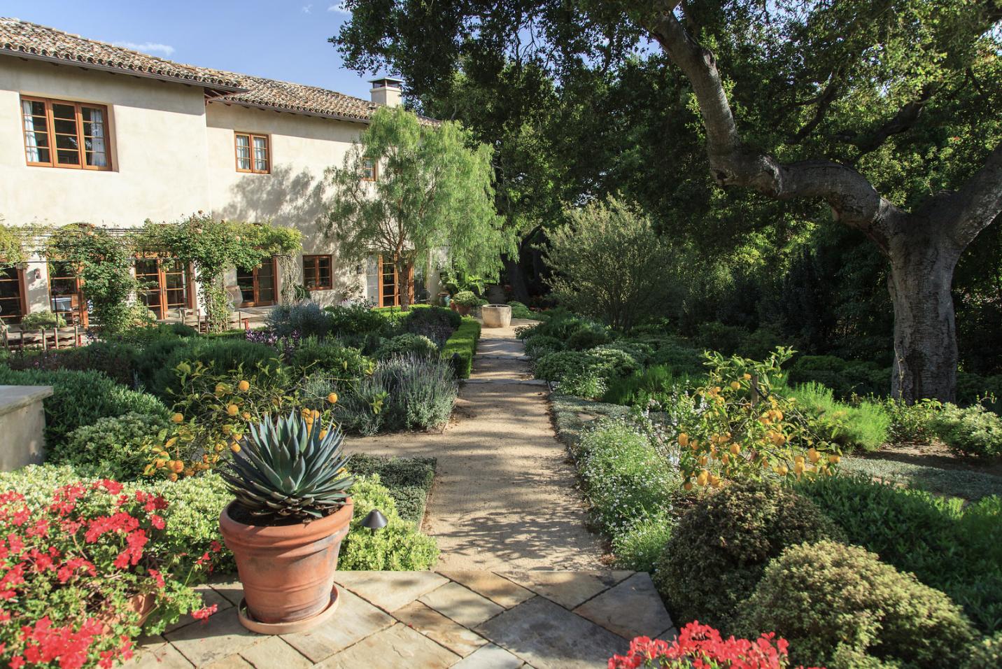 854 Rockbridge Road Santa Barbara, CA 93108 - Photo 26 of 34 a front view of a house with a yard and potted plants