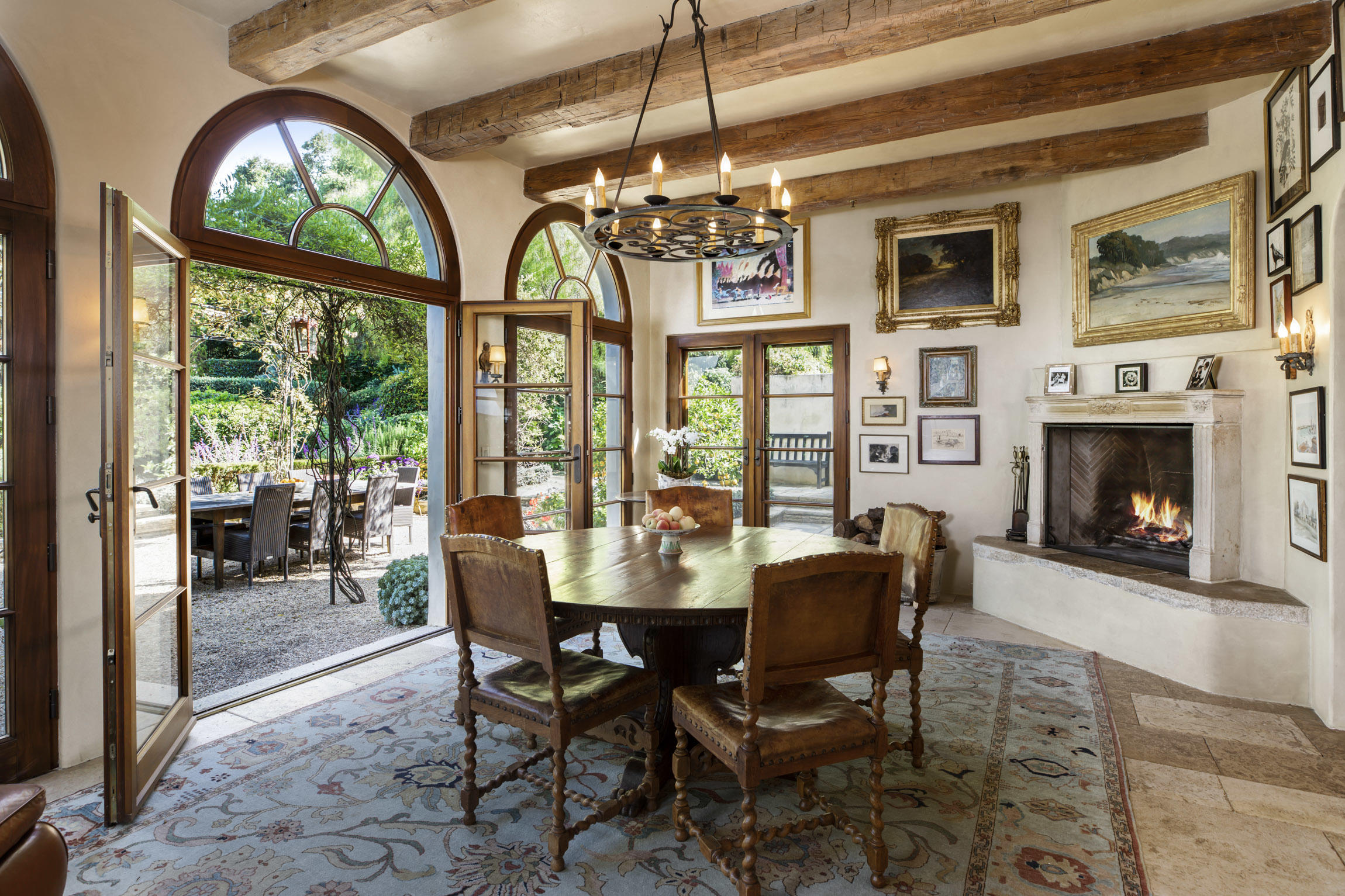 854 Rockbridge Road Santa Barbara, CA 93108 - Photo 8 of 34 a dining room with furniture a fireplace and large windows