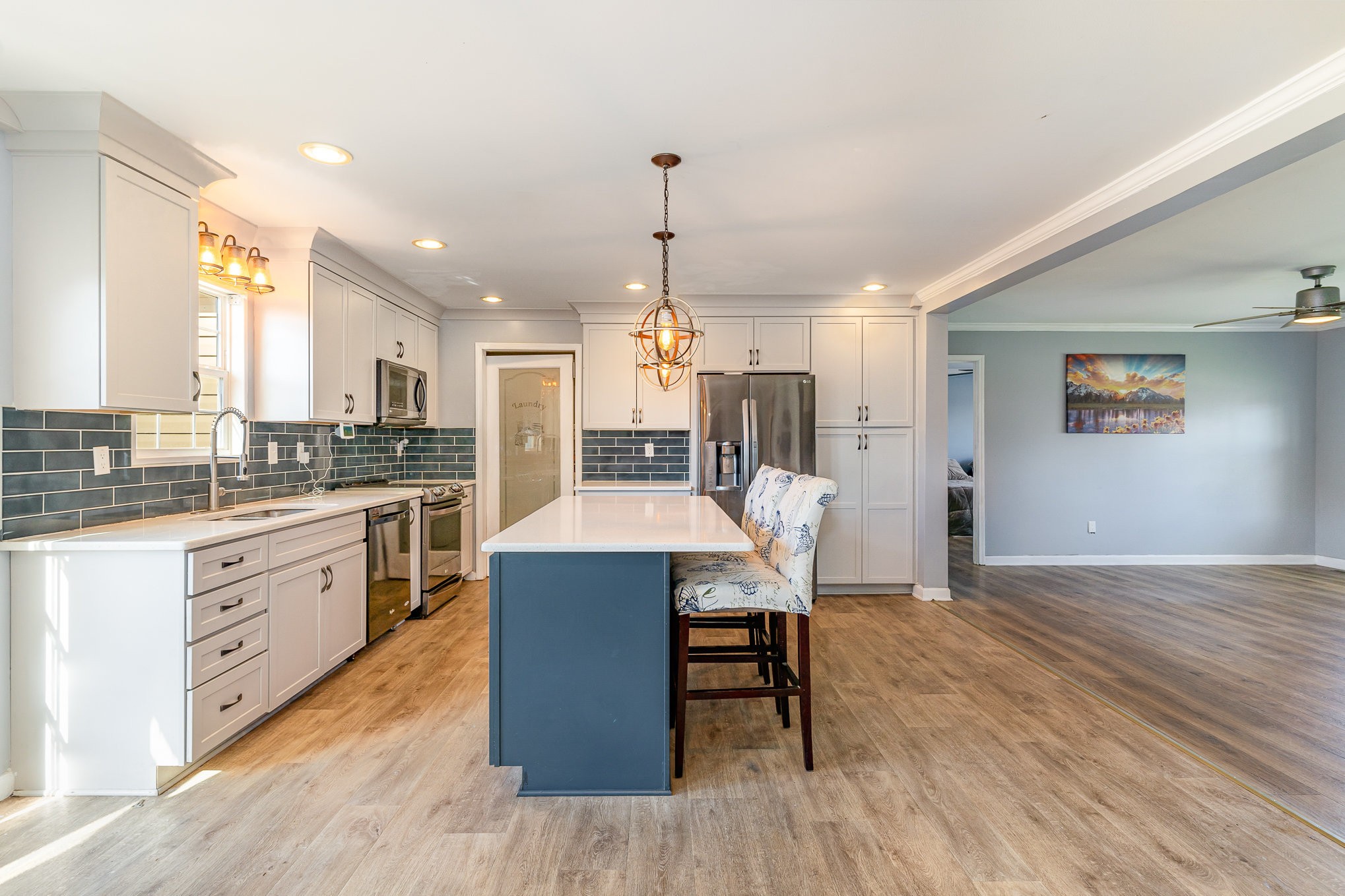 1159 Wrights Mill Road Spring Hill, TN 37174 - Photo 8 of 16 a kitchen with granite countertop a table chairs a sink dishwasher refrigerator and wooden floor