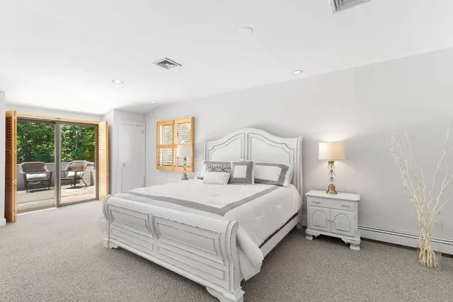 a bedroom with a bed and a large window