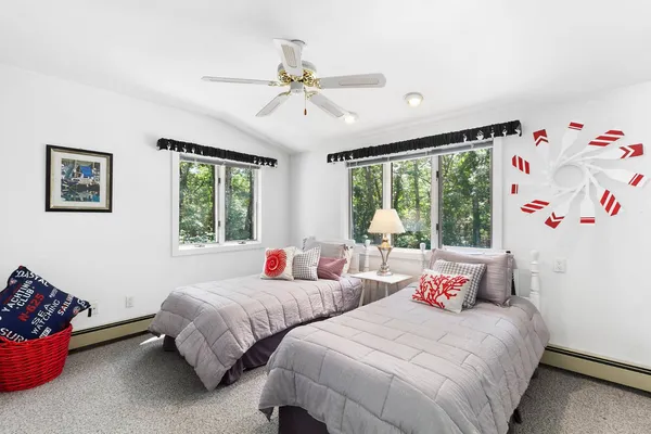 a bedroom with two beds and a large window