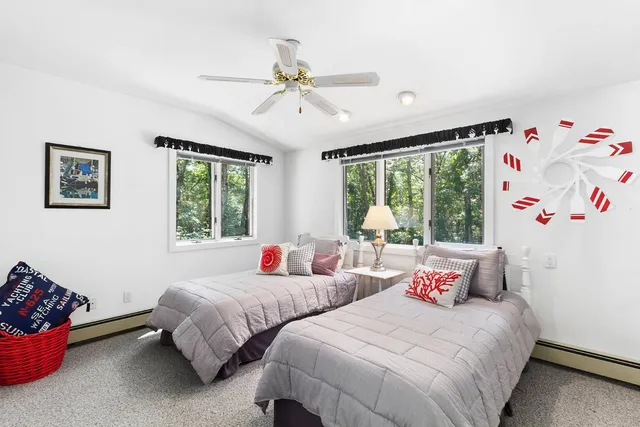 a bedroom with two beds and a large window