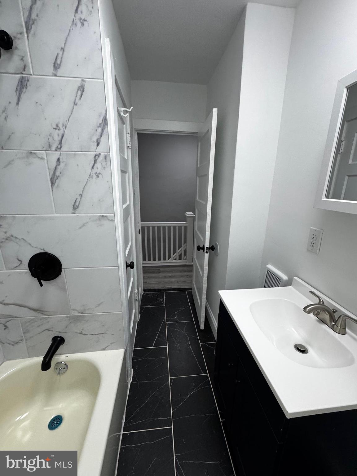 2656 Shields Street Philadelphia, PA 19142 - Photo 11 of 15 a bathroom with a sink and a mirror