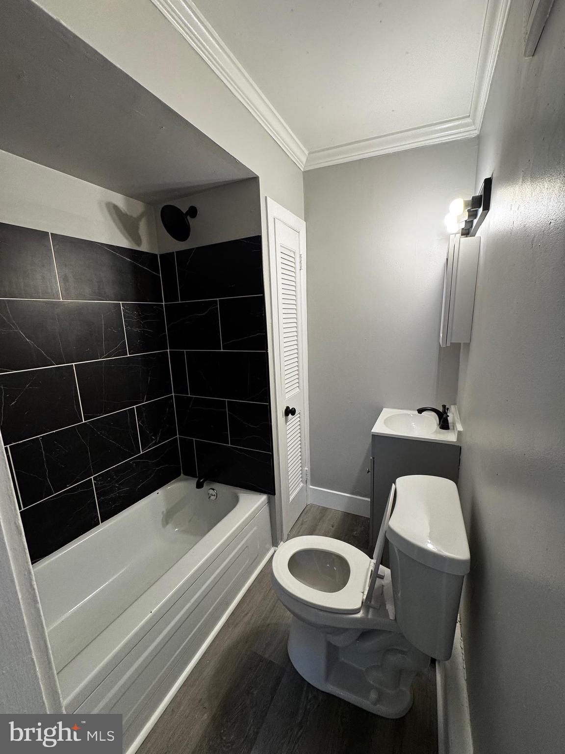2656 Shields Street Philadelphia, PA 19142 - Photo 4 of 15 a bathroom with a toilet a sink and bathtub
