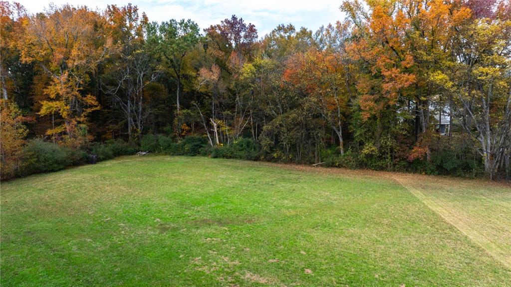 84 Cline Smith Road Northeast Cartersville, GA 30121 - Photo 12 of 14 a view of a field with a trees in the background