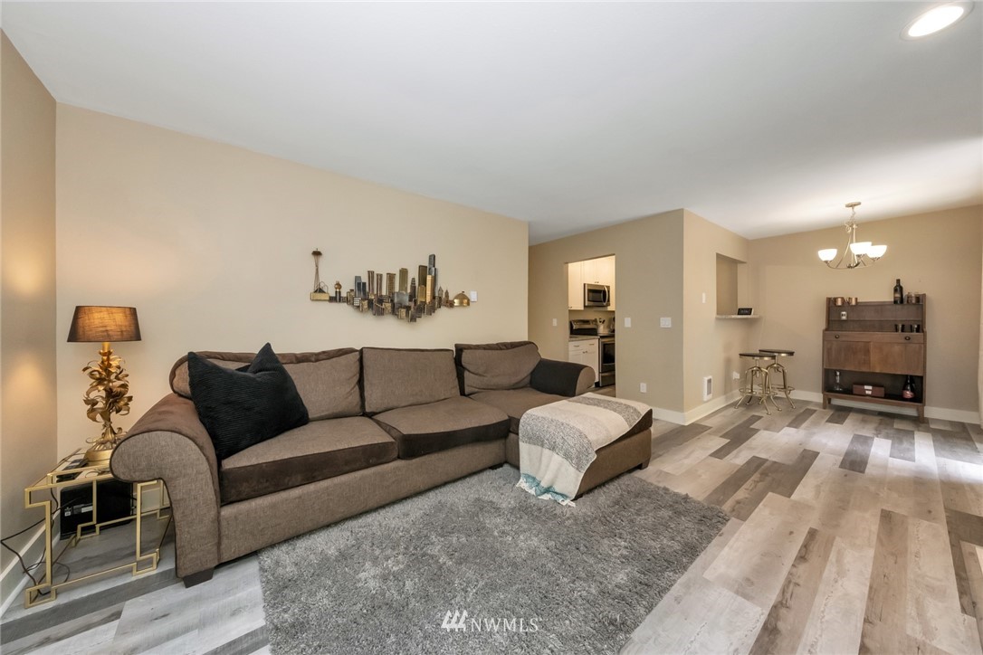 a spacious bedroom with a bed a couch and dresser