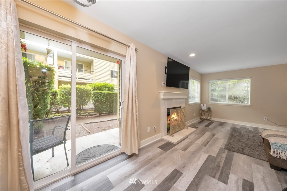 455 Newport Way Northwest, Unit 302 Issaquah, WA 98027 - Photo 2 of 17 a view of livingroom with furniture and fireplace