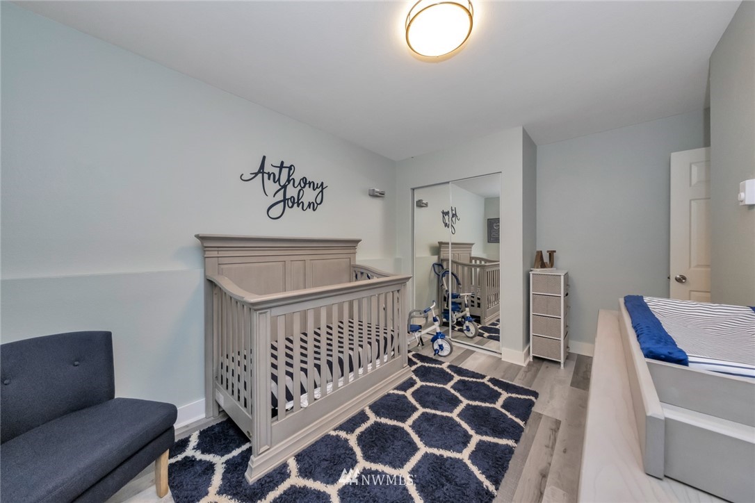 455 Newport Way Northwest, Unit 302 Issaquah, WA 98027 - Photo 13 of 17 a bedroom with furniture and wooden floor