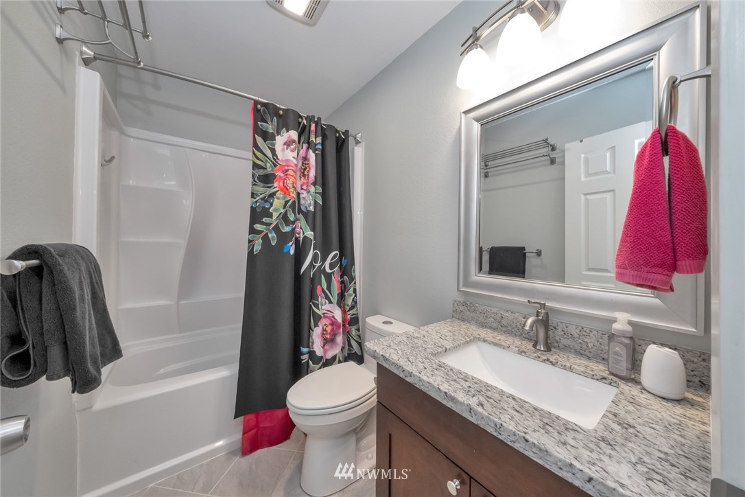 455 Newport Way Northwest, Unit 302 Issaquah, WA 98027 - Photo 14 of 17 a bathroom with a granite countertop sink and a mirror