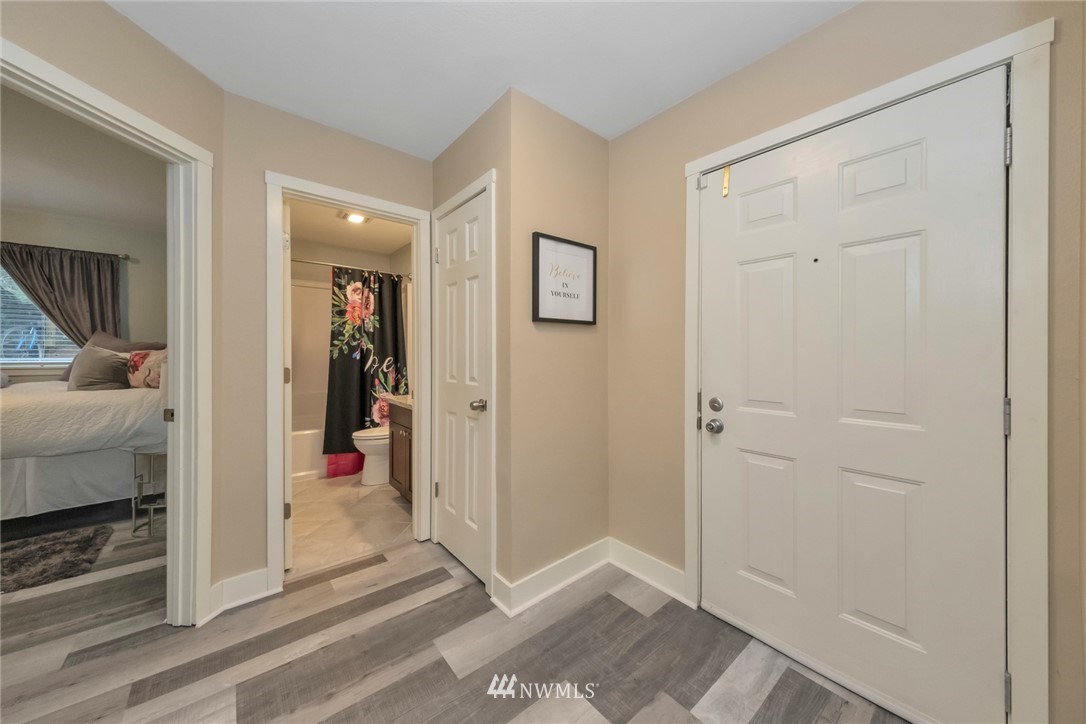455 Newport Way Northwest, Unit 302 Issaquah, WA 98027 - Photo 7 of 17 a view of a hallway with closet and a couch