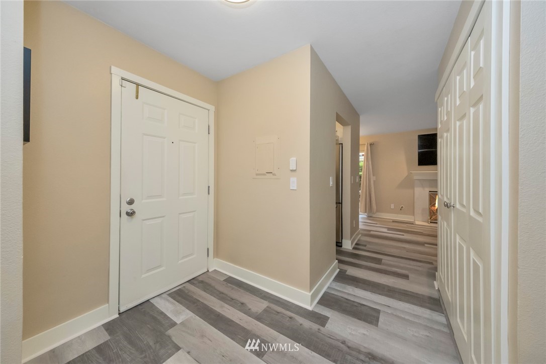 455 Newport Way Northwest, Unit 302 Issaquah, WA 98027 - Photo 8 of 17 a view of a hallway with wooden floor and entryway