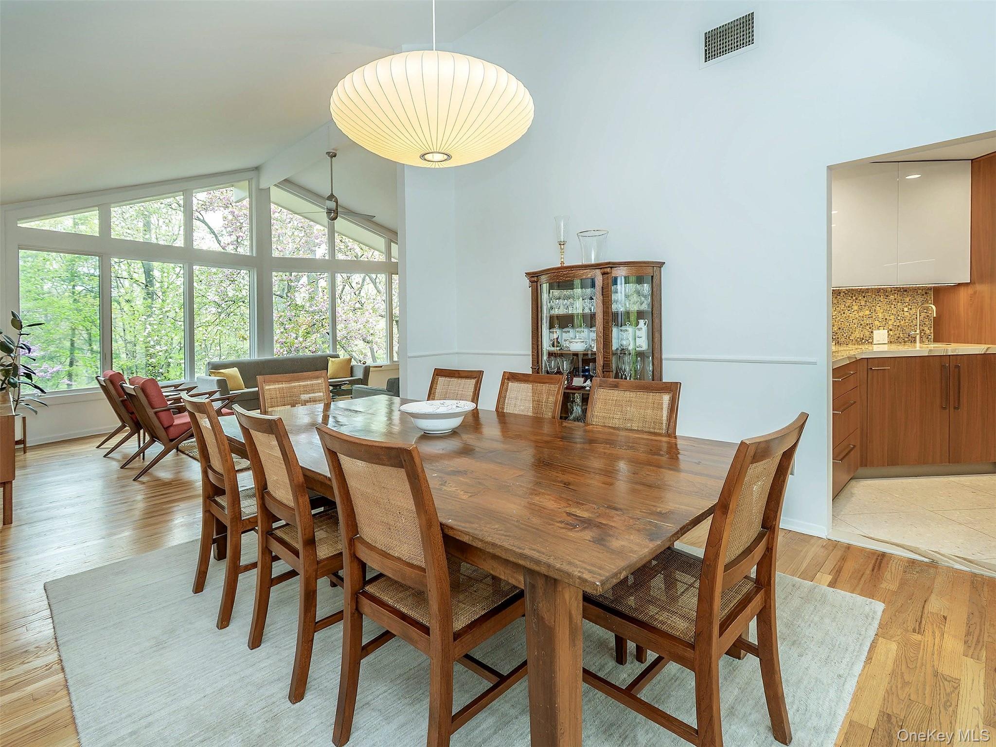 7 SE Road Sands Point, NY 11050 - Photo 13 of 45 a view of a dining room with furniture wooden floor and chandelier