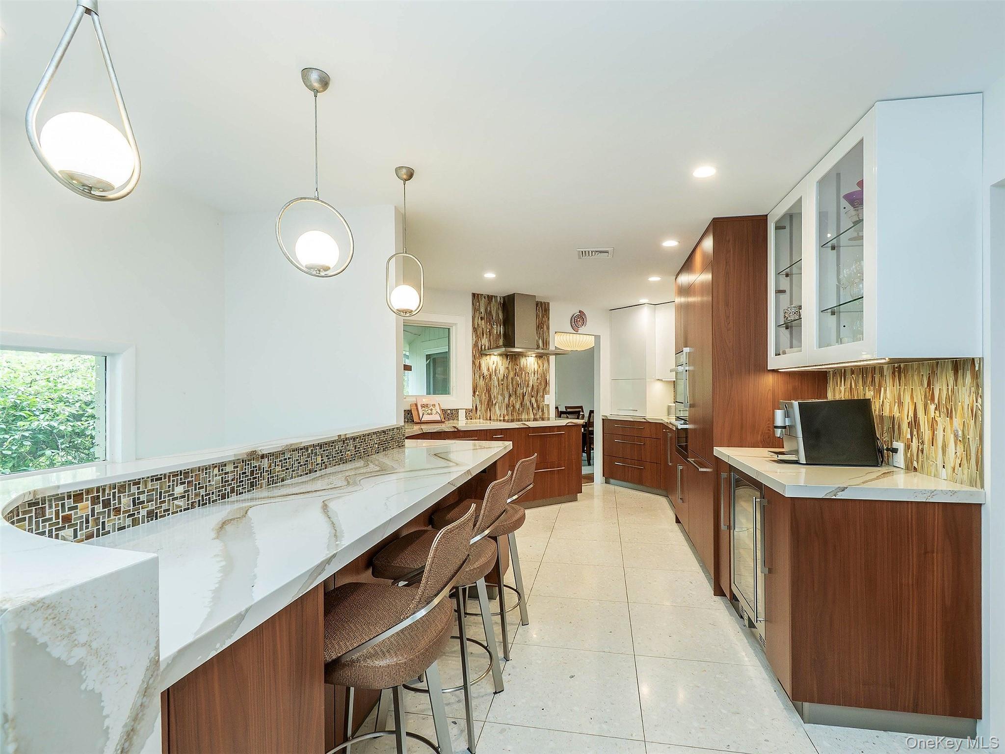 7 SE Road Sands Point, NY 11050 - Photo 17 of 45 a large kitchen with kitchen island a sink counter space and stainless steel appliances