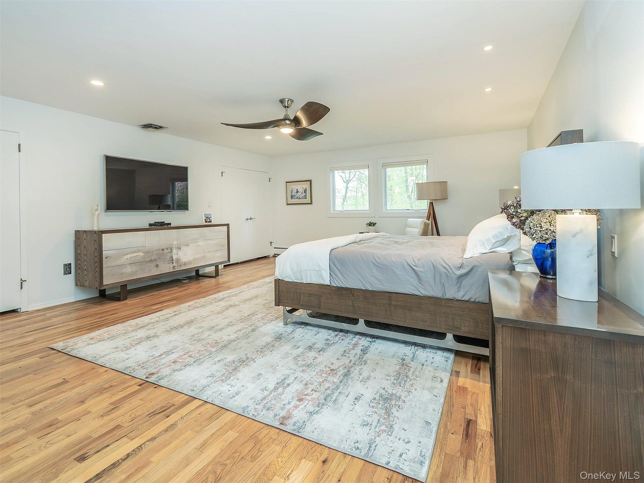 7 SE Road Sands Point, NY 11050 - Photo 21 of 45 a bedroom with a bed and a flat screen television