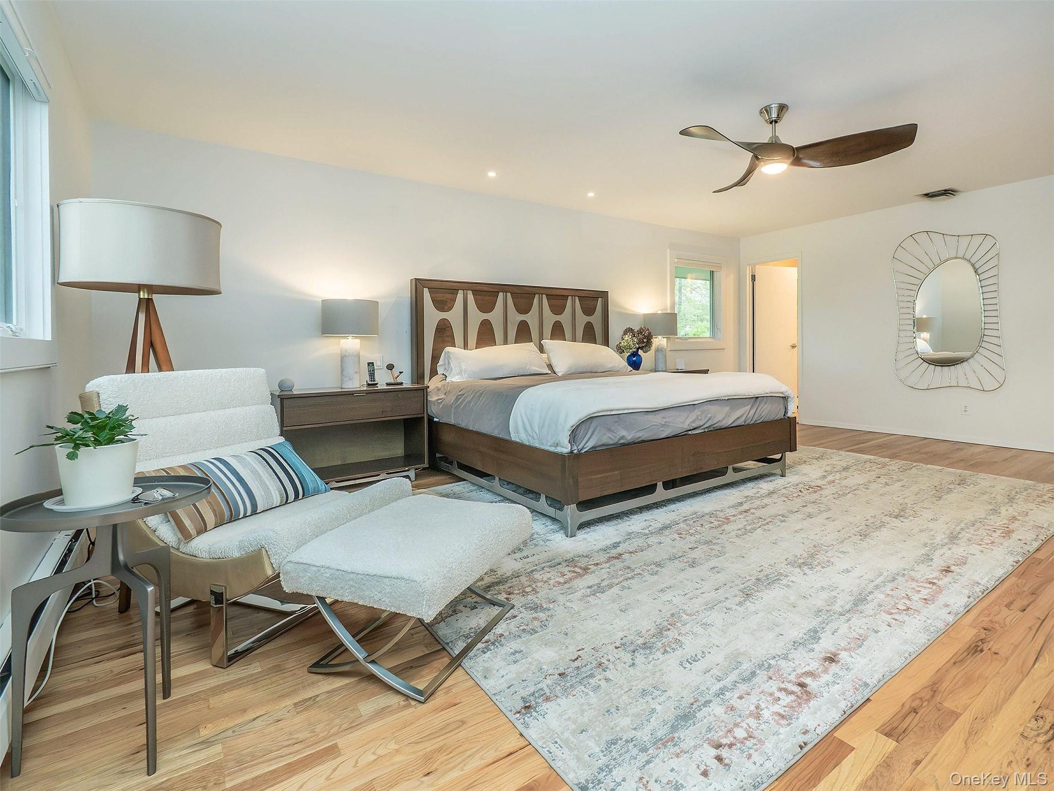 7 SE Road Sands Point, NY 11050 - Photo 22 of 45 a spacious bedroom with two beds and painting on the wall