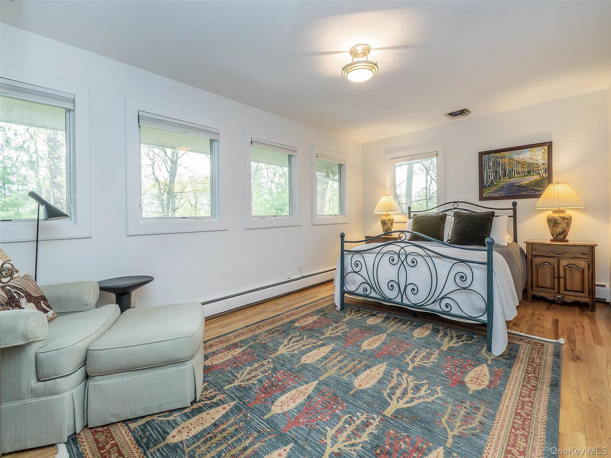 7 SE Road Sands Point, NY 11050 - Photo 24 of 45 a bedroom with a bed and wooden floor