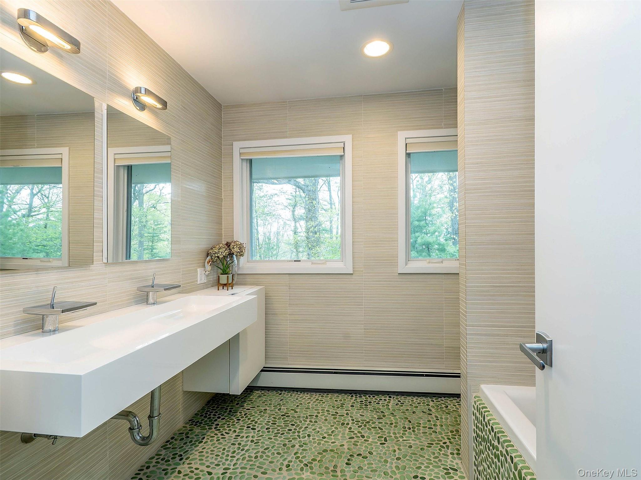 7 SE Road Sands Point, NY 11050 - Photo 26 of 45 a bathroom with a sink and a mirror