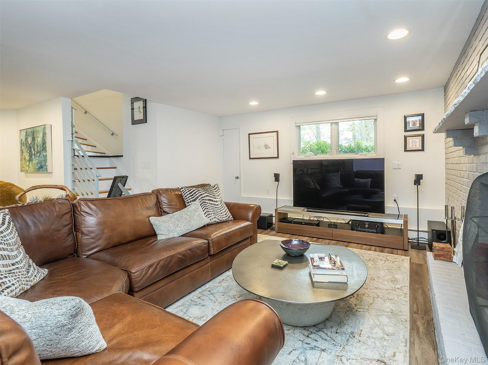 7 SE Road Sands Point, NY 11050 - Photo 28 of 45 a living room with furniture and a flat screen tv