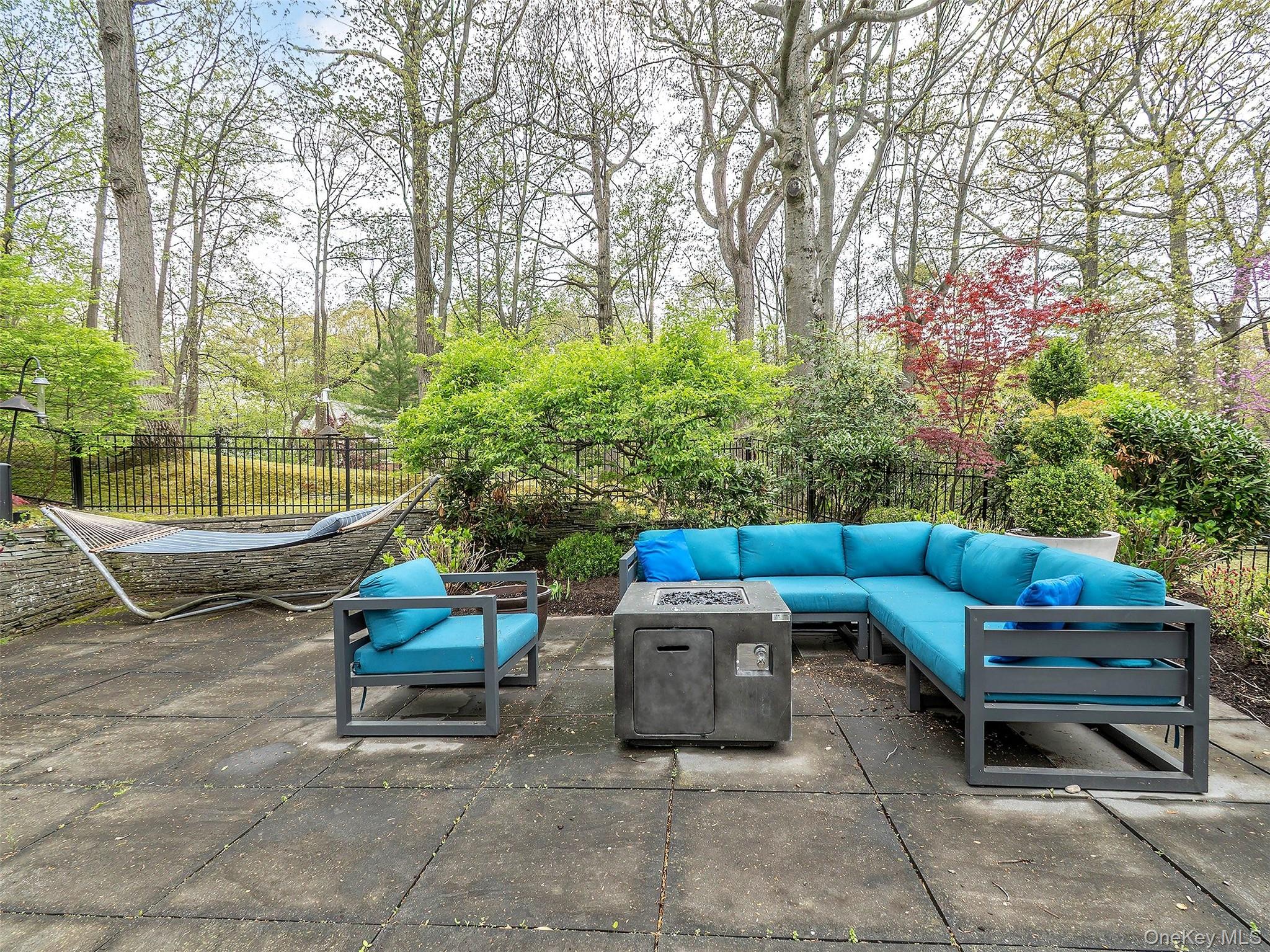 7 SE Road Sands Point, NY 11050 - Photo 39 of 45 a backyard of a house with barbeque oven table and chairs