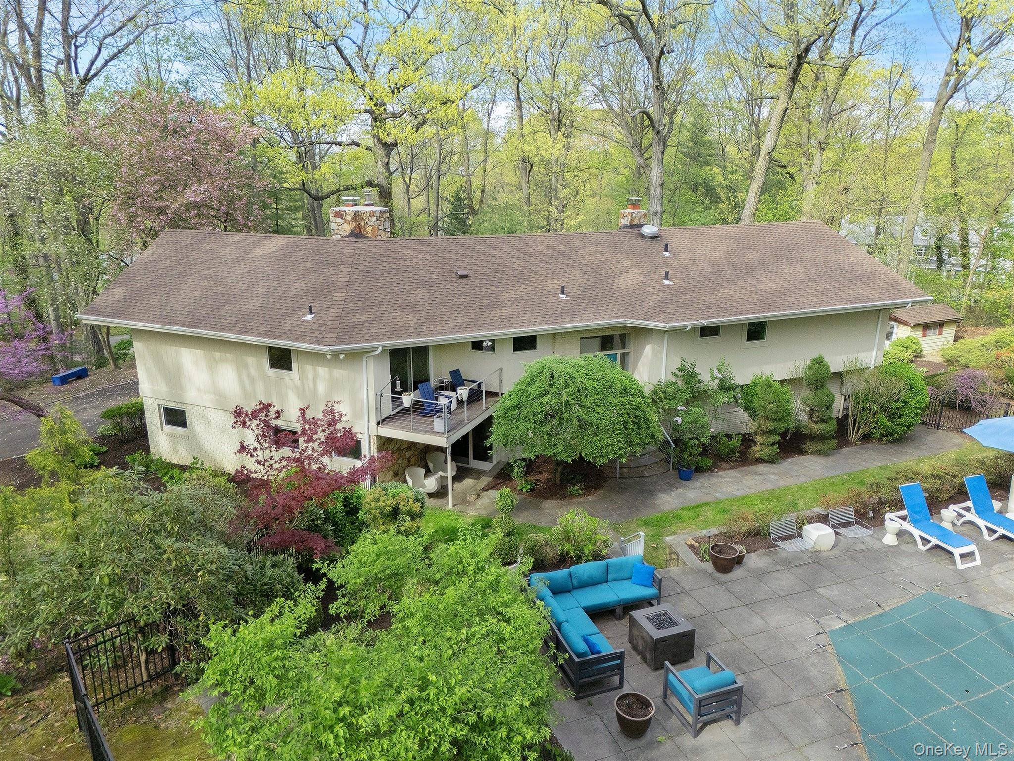 7 SE Road Sands Point, NY 11050 - Photo 41 of 45 a view of backyard with table and chairs and plants
