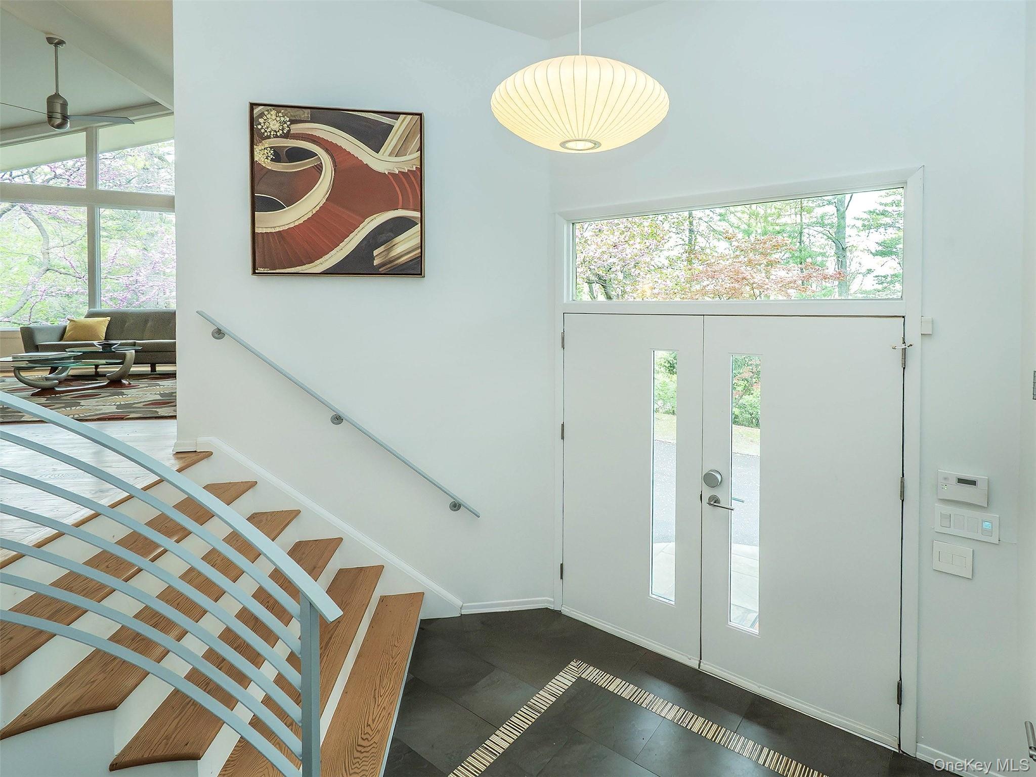 7 SE Road Sands Point, NY 11050 - Photo 5 of 45 a view of a hallway with wooden floor and a large window