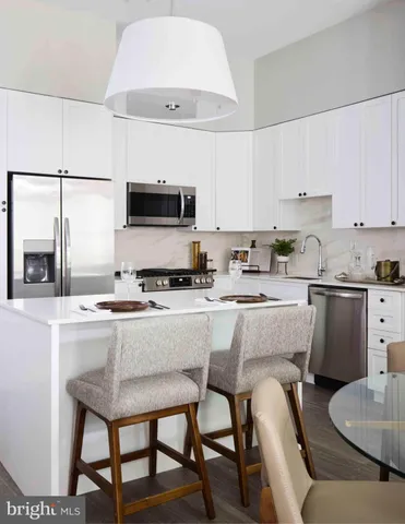 a kitchen with a stove a sink and a refrigerator