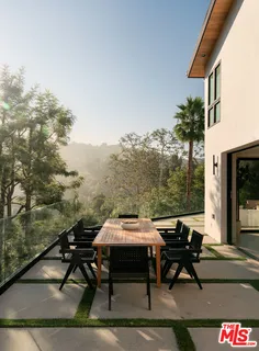 a view of a roof deck with table and chairs and couches