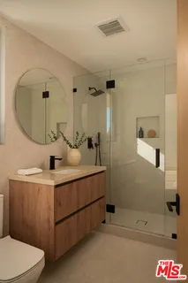 a bathroom with a sink mirror and vanity