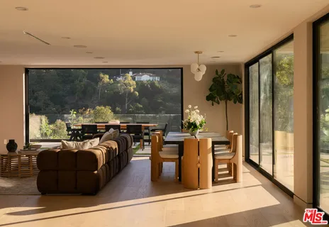 a room with furniture and a floor to ceiling window