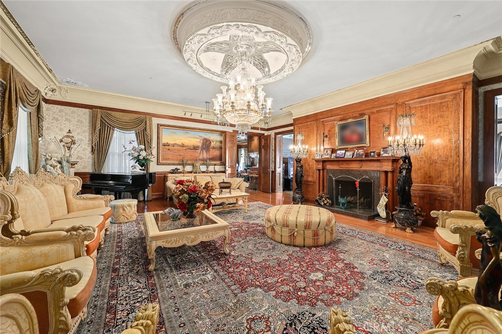 999 Rosalind Road San Marino, CA 91108 - Photo 12 of 70 a living room with furniture a fireplace and a chandelier