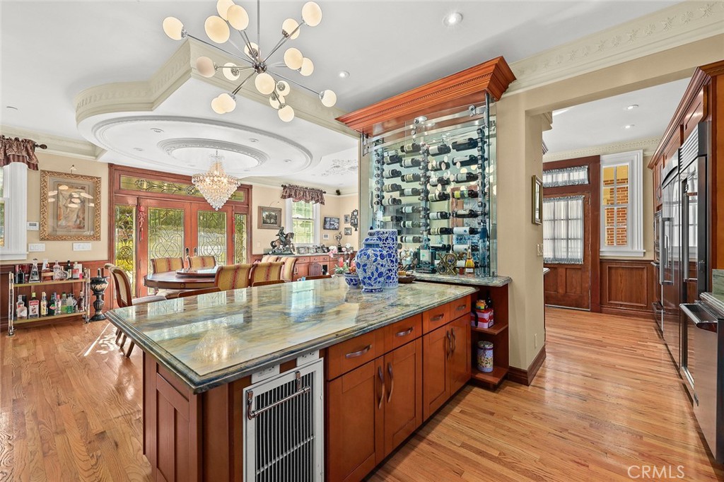 999 Rosalind Road San Marino, CA 91108 - Photo 16 of 70 a kitchen with a stove a sink dishwasher and a dining table with the kitchen view