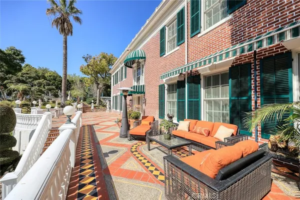 a view of a patio with table and chairs potted plants with wooden floor and fence